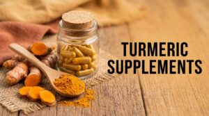 Turmeric supplements: a jar of turmeric capsules with a spoon of turmeric powder and fresh turmeric root